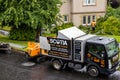 Professional tree surgeon`s truck with hopper and shredder machinery for collecting tree and shrub chippings