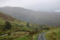 Female walker on track to Hartsop from Hayeswater Royalty Free Stock Photo