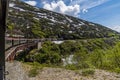 A view down a train crossing a bridge over a ravine on the White Pass and Yukon railway near Skagway, Alaska