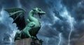 View of the Dragon bridge Zmajski most, symbol of Ljubljana, capital of Slovenia, Europe. Sculpture of a dragon against a dark Royalty Free Stock Photo