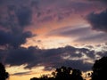 View of the dramatic sky above the sity at sunset with dark blue clouds