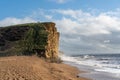 A view of the dramatic sunlit cliffs at West Bay, Dorset, UK.