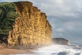 A view of the dramatic sunlit cliffs at West Bay, Dorset, UK.