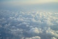 View of dreamy fluffy abstract white cloud with blue sky and sunrise light background from airplane window Royalty Free Stock Photo