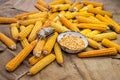View of dried corn with bowl of corn kernels and manual hand tool to clean maize on jute sack Royalty Free Stock Photo