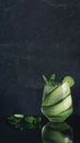 View of drinking glass with cucumber tonic gin cocktail with fresh mint on glossy black table and background refreshing long drink Royalty Free Stock Photo