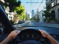 view from the driver\'s seat behind the wheel of a city street Royalty Free Stock Photo