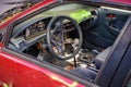 View of driving wheel and dash board of destroyed abandoned car