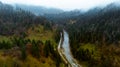 View from a drone above river, road and autumn forest in the Carpathian mountains Royalty Free Stock Photo