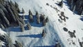 The view from the drone. Man walking on a snowy ridge in the mountains. Royalty Free Stock Photo