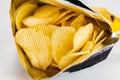 View of dry crispy fried corrugated potato chips in open bag Royalty Free Stock Photo