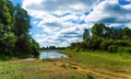 View of the dry river from hot weather against the green vegetation of trees and blue sky Royalty Free Stock Photo