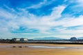 View of a dry salt marsh from bicycle and pedestrian trail in Silicon Valley with Moffett Field hangars and Santa Cruz Mountains