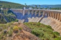 View of the dry spillway of a concrete dam during a long drought