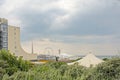 View from the dunes on apartment building, terraces and ferris wheel on the coast of Scheveningen on a cloudy day