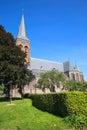 View on dutch neo gothic church from 18th century with green trees against blue summer sky - Baak, Sint Martinuskerk, Netherlands Royalty Free Stock Photo