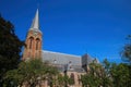 View on dutch neo gothic church from 18th century with green trees against blue summer sky - Baak, Sint Martinuskerk, Netherlands