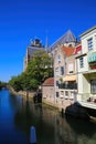 View on dutch water canal with residential houses and gothic church background - Dordrecht, Netherlands Royalty Free Stock Photo