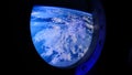 View of the Earth through the porthole of spaceship. International space station Royalty Free Stock Photo