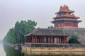 East corner of Palace Museum at the Forbidden City and surrounding moat filled with water with dramatic cloudscapes in Beijing Ch