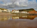 View of the easten end of Sidmouth Esplanade and sandstone cliff. This cliff has regular rockfalls which reduce the lengths of the Royalty Free Stock Photo