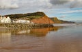 View of the easten end of Sidmouth Esplanade and sandstone cliff. This cliff has regular rockfalls which reduce the lengths of the Royalty Free Stock Photo