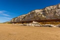 A view eastward along the white, red and orange stratified chalk cliffs of Old Hunstanton, Norfolk, UK Royalty Free Stock Photo