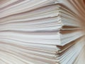 View of the edge of a bundle of sheets of white paper.