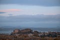 View of Edinburgh city centre and castle with the sea in the background and a flying plane in the sky Royalty Free Stock Photo