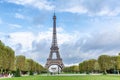 View of the Eiffel Tower from an autumn park against a blue sky. Walking people are photographed Royalty Free Stock Photo