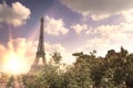 View on Eiffel tower through green summer trees with sunset rays. Beautiful Romantic background. Eiffel Tower from Champ Royalty Free Stock Photo