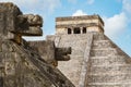 View of El Castillo (Temple of Kukulkan) behind carved jaguar heads