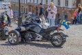 View of elderly tourist capturing moment with his camera, photographing unique motorcycle adorned with national Swedish flag.