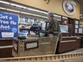 Kirkland, WA USA - circa October 2021: View of an elderly woman picking up a prescription at a pharmacy inside a Safeway grocery Royalty Free Stock Photo