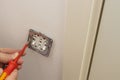 View of electrician repairing wall light switch panel. Royalty Free Stock Photo