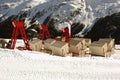 A view of elevated chairs and lounges in the snow covered landscape and mountains in St Moritz Switzerland in the alps