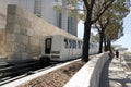 A view of an elevated tram rail and a highway passing cars in Los Angeles, California