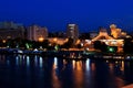 View of the embankment of Dnipro, Ukraine from the New Bridge at night, lights reflected in the water. Royalty Free Stock Photo
