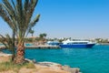 View of embankment of Hurghada with moored yachts, ships and beautiful palm trees