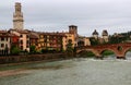 View of the embankment, the Ponte Pietra bridge over the Adige river and the tower of the Cathedral in Verona, Italy Royalty Free Stock Photo