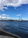 View from the embankment of the sailing ship Poltava and warships in the Neva river. Preparation for the naval parade in St. Royalty Free Stock Photo