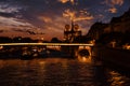View of the embankment of the Seine River and Notre Dame de Paris at sunset
