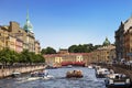 View of the embankments of the Moika river, tourist boats, the Red bridge and the Trading house `S. Esders and K. Skheifals` in