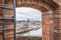 View through an embrasure in the castle wall of the fortress Feste Oberhaus near the three rivers city Passau with view on the cit