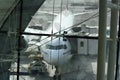 View of Emirates Airlines airplane parking on apron viewed from waiting lounge inside the terminal at Dubai Intenational Airport Royalty Free Stock Photo