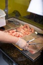 employee restocks Mongolian BBQ restaurant meat