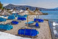 View of empty beach -  blue deck chairs and shade umbrellas Royalty Free Stock Photo