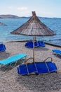 View of empty beach - blue deck chairs and shade umbrellas Royalty Free Stock Photo