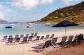 View of empty beach chairs next to the water in the Caribbean island of Tortola. Royalty Free Stock Photo