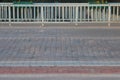 view of an empty bike path and a paved road in the city, a fence, a curb stone and white road markings, minimalism. Royalty Free Stock Photo